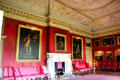 French red damask wall coverings by John Dawson covered by collection of paintings in Red Drawing Room at Hopetoun House. Queensferry, Scotland.