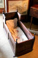 Antique wooden cradle in West Wainscot Bedchamber at Hopetoun House. Queensferry, Scotland.