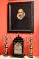 Portrait over decorative candlesticks & clock in Reception Hall at Lauriston Castle. Edinburgh, Scotland.