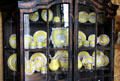 Chinoiserie cabinet with yellow Derby porcelain set in tea room at Manderston House. Duns, Scotland.