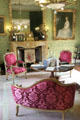 French Empire style seating before large drawing room fireplace at Thirlestane Castle. Scotland.