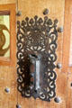 Metalwork door knocker on front door at Traquair House. Scotland.