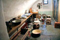Cellar room once used as dairy displays churns at Traquair House. Scotland.