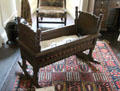 King's room with cradle once used by baby King James VI of Scotland at Traquair House. Scotland.