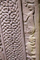 Pictish Droston stone front detail of lace of cross edged by compressed camel & lion at St Vigeans Museum. Arbroath, Scotland.