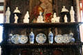Porcelain figures & plates on fireplace mantle in Queen Mother sitting area at Glamis Castle. Angus, Scotland.