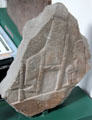 Pictish cross-slab shows servant sitting behind master's chair at Meigle Sculptured Stone Museum. Meigle, Scotland.
