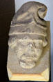 Stone corbel carved in shape of head with cap in museum at St Andrews Cathedral. St Andrews, Scotland.