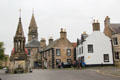 Falkland High Street with Bruce Fountain, Town Hall, 1717 hotel with quoins & Seyton House. Falkland, Scotland.