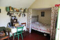 Early 20th C farmhouse with curtained inset bed at Highland Folk Museum. Newtonmore, Scotland.