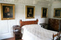 Tartan bedroom with family portraits at Craigievar Castle. Alford, Scotland.