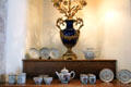 Vase centerpiece with porcelain pieces with heraldic crests at Drum Castle. Drumoak, Scotland.