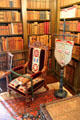 Armchair & family crest banner in library at Drum Castle. Drumoak, Scotland.