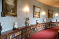 Curved hallway lined with paintings, bust & books at Haddo House. Methlick, Scotland.