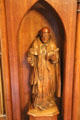 Carved religious figure on fireplace in red drawing room at Brodie Castle. Brodie, Scotland.