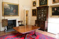 Lady Macduff's dressing room with table, display cabinet & paintings at Duff House. Banff, Scotland.