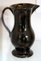 Black glazed earthenware jug with loop handle at Coalport China Museum. Ironbridge, England.