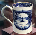 Caughley Porcelain cylindrical mug transfer printed with view of Iron Bridge at Coalport China Museum. Ironbridge, England.