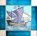 Sailing ship with dolphins hand-painted tile by William De Morgan at Jackfield Tile Museum. Ironbridge, England.