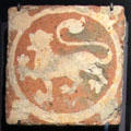 Medieval inlaid clay heraldic lion floor tile from Keynsham Abbey, Somerset at Gladstone Pottery Museum. Longton, Stoke, England