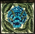 Blue flower tile by W De Morgan, Sands End at Gladstone Pottery Museum. Longton, Stoke, England.