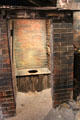 Replica of Medieval outdoor courtyard one-holer toilet in bathroom history gallery at Gladstone Pottery Museum. Longton, Stoke, England.