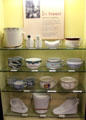 Collection of chamber pots by several Staffordshire potteries in bathroom history display at Gladstone Pottery Museum. Longton, Stoke, England.