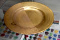 Demonstration of gilding stages for hand burnishing gold applied to china plate at Gladstone Pottery Museum. Longton, Stoke, England.