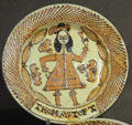 Slip decorated dish showing man in coat & feather hat toasting with wine glass by Thomas Toft of North Straffordshire at Potteries Museum & Art Gallery. Hanley, Stoke-on-Trent, England.