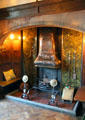 Lower hall fireplace with several elements including the copper canopy possibly from Morris & Co at Wightwick Manor. Wolverhampton, England.