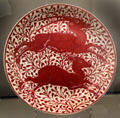 Ruby lustre antelope plate by William De Morgan at Ashmolean Museum. Oxford, England.
