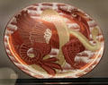 Ruby lustre plus gold dragon & snake plate by William De Morgan at Ashmolean Museum. Oxford, England.