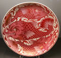 Ruby lustre fish dish by William De Morgan at Ashmolean Museum. Oxford, England.