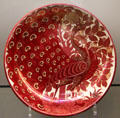 Ruby lustre peacock dish by Charles Passenger for William De Morgan at Ashmolean Museum. Oxford, England.