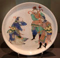 Porcelain dish painted overglaze with Chinese figures made in China at Ashmolean Museum. Oxford, England.