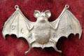 Silver claret bottle label in shape of bat at Ashmolean Museum. Oxford, England.