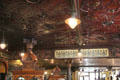 Tin ceiling over alphabetic call board to indicate client needs at Crown Liquor Saloon. Belfast, Northern Ireland.