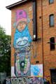Mural of youngster listening to tape recorder. Belfast, Northern Ireland.