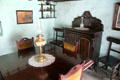 Dining table with oil lamp plus sideboard in Coshkib Hill Farm at Ulster Folk Park. Belfast, Northern Ireland.