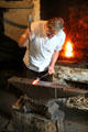 Blacksmith working in Lisrage Forge at Ulster Folk Park. Belfast, Northern Ireland.