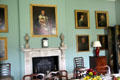 Dining room fireplace surrounded by portraits at Florence Court. Enniskillen, Northern Ireland.