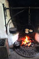 Griddle cakes on andiron over fire in Mellon Homestead at Ulster American Folk Park. Omagh, Northern Ireland.