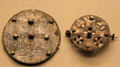 Anglo-Saxon silver sheet disc brooch with Trewhiddle-style decoration plus openwork brooch both from Beeston Tor Hoard at British Museum. London, United Kingdom.