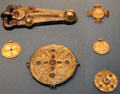 Anglo-Saxon metallic buckle & brooches showing transition to Christianity several from Kent, England at British Museum. London, United Kingdom.