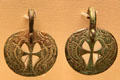 Christianized Celtic bronze bowl mounts with dolphins framing a cross from Faversham, Kent at British Museum. London, United Kingdom.