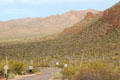 Road through Sonoran Desert hills with Saguaro cacti. Tucson, AZ.