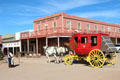 Stage coach passes Golden Eagle Brewery Saloon. Tombstone, AZ.