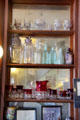 Collection of Kings Crown glassware & bottles on bar at Bird Cage Theatre. Tombstone, AZ.