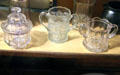 Pressed glass sugar bowl & two-handled cups at Bird Cage Theatre. Tombstone, AZ.