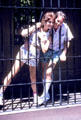 Visitors test rubber jail bars showing fakery of movies at Universal Studios. Universal City, CA.